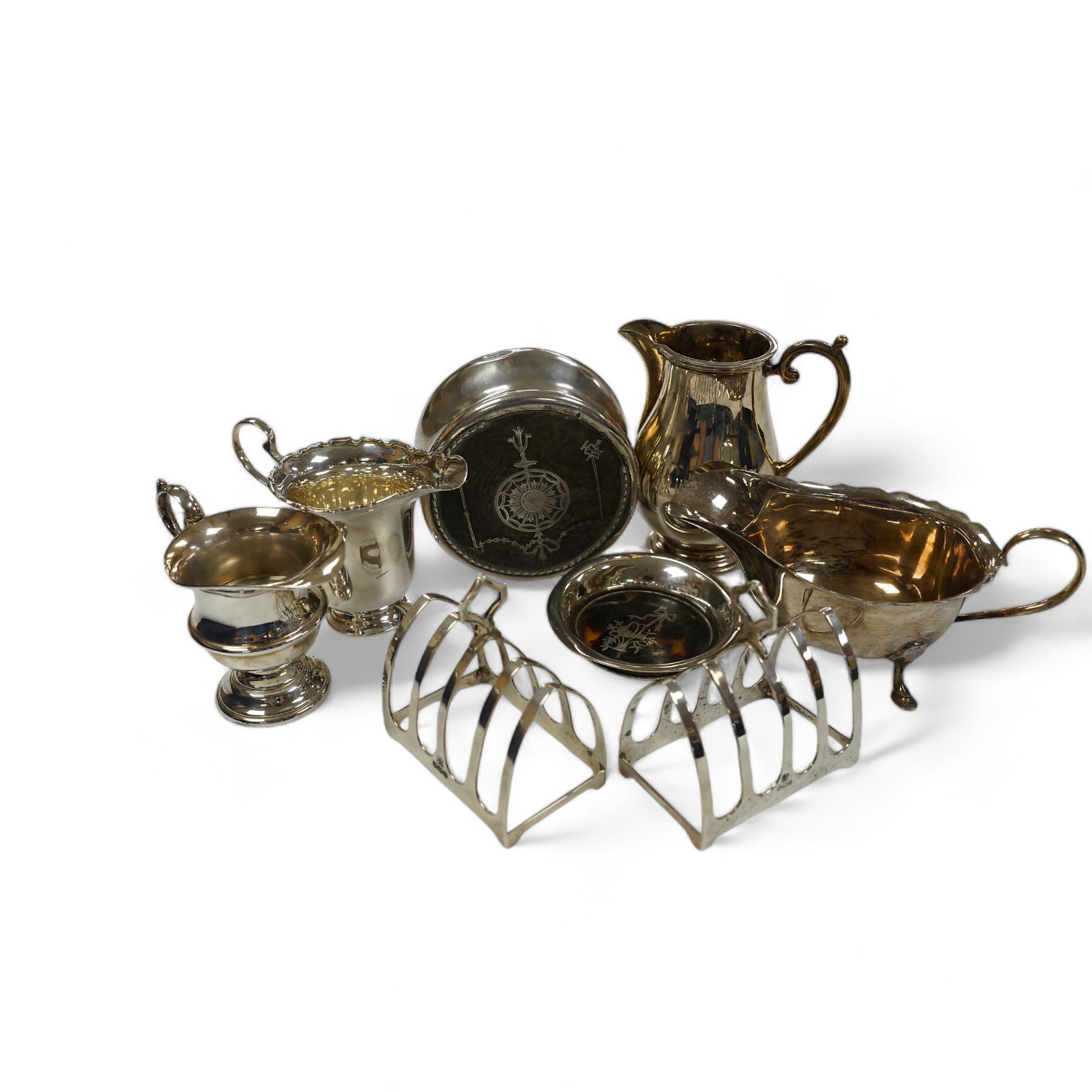 Sundry small silver including a pair of toast racks, Sheffield, 1936, three cream jugs, a sauceboat and two tortoiseshell mounted items. Condition - poor to fair to good